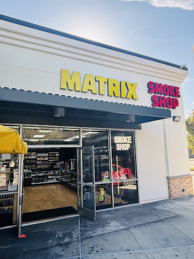 A store front with a yellow umbrella outside